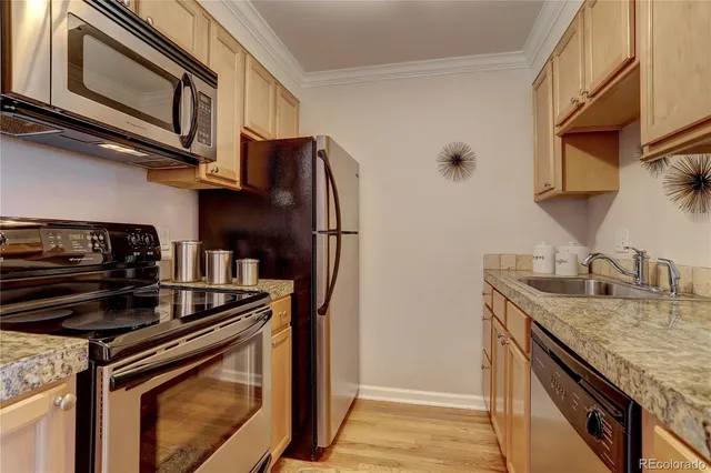 a kitchen with stainless steel appliances granite countertop a stove and a refrigerator