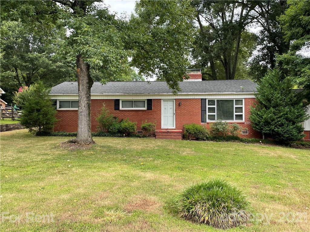 a front view of house with yard and green space