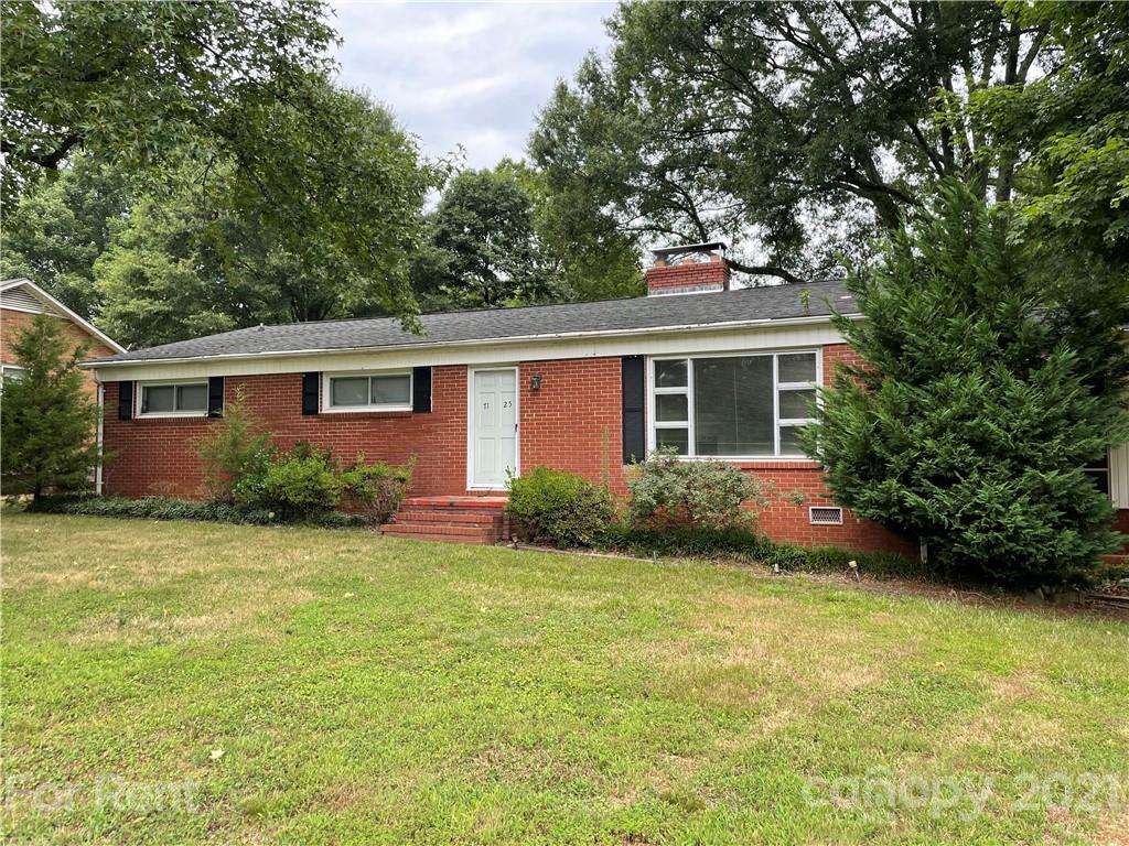 7125 Pence Road, Unit 2 Charlotte, NC 28215 - Photo 2 of 16 a house that has a tree in front of it