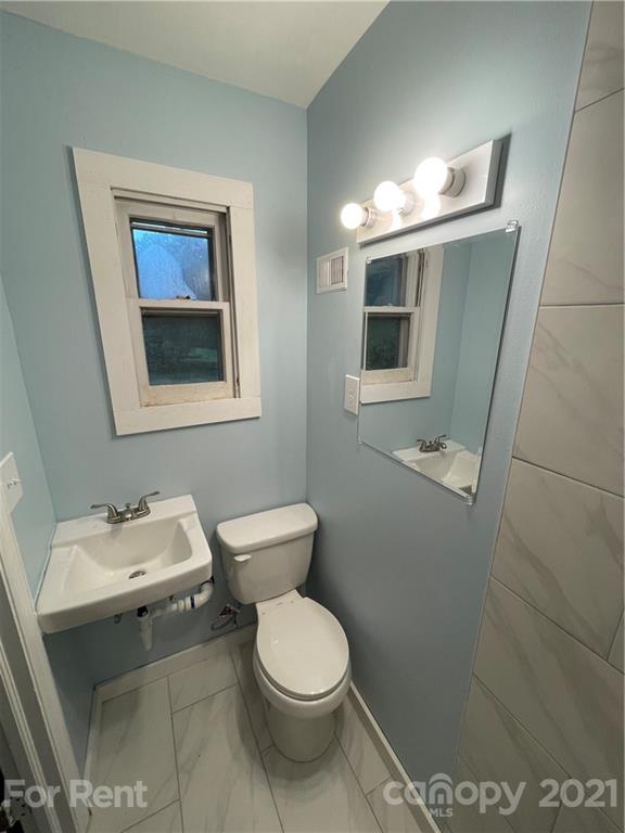 7125 Pence Road, Unit 2 Charlotte, NC 28215 - Photo 16 of 16 a bathroom with a toilet sink and mirror