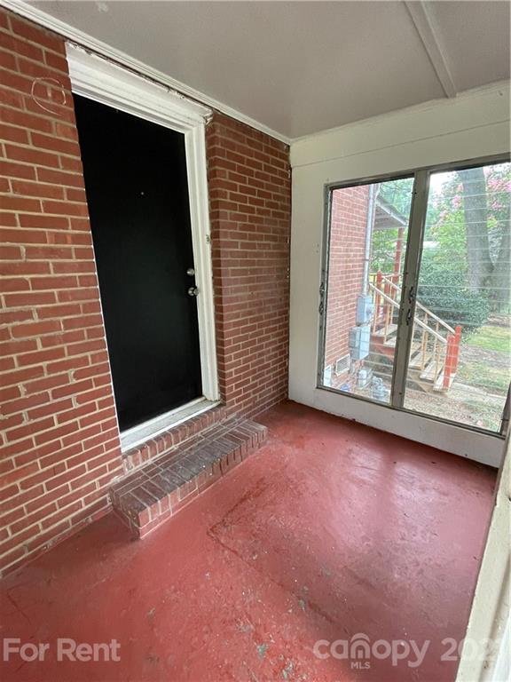 7125 Pence Road, Unit 2 Charlotte, NC 28215 - Photo 4 of 16 a view of an empty room with a fireplace and a window