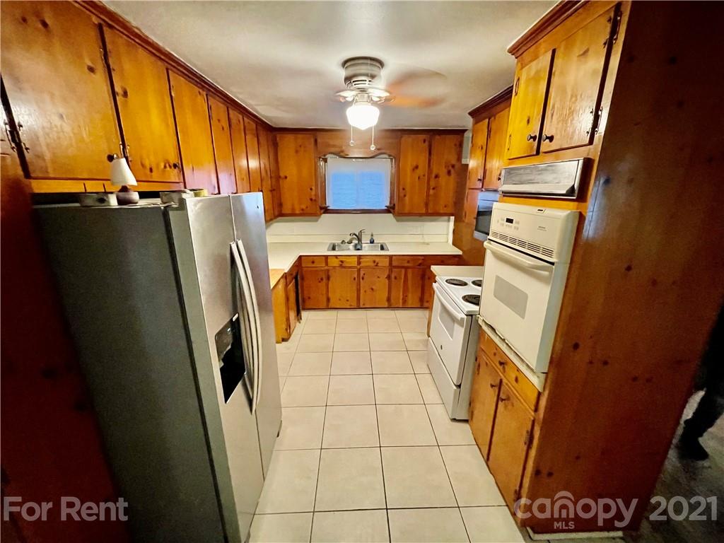 7125 Pence Road, Unit 2 Charlotte, NC 28215 - Photo 6 of 16 a kitchen with stainless steel appliances granite countertop a refrigerator and a stove
