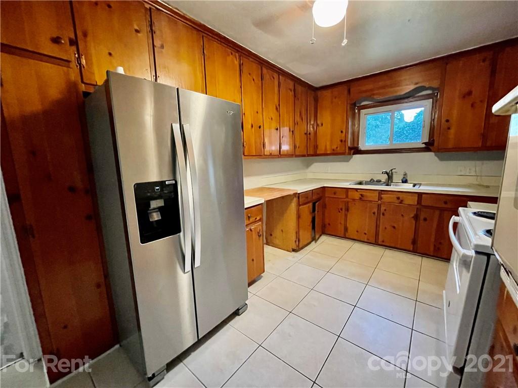 7125 Pence Road, Unit 2 Charlotte, NC 28215 - Photo 7 of 16 a kitchen with stainless steel appliances a refrigerator sink and cabinets
