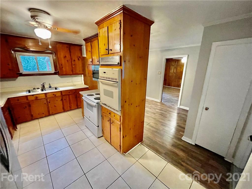 7125 Pence Road, Unit 2 Charlotte, NC 28215 - Photo 8 of 16 a kitchen with stainless steel appliances granite countertop a refrigerator and a stove