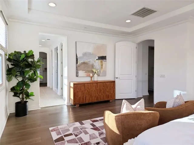 a living room with furniture and a potted plant