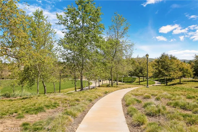 a view of a swimming pool with a garden and trees