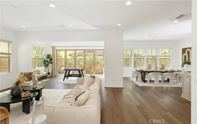 a living room with furniture and floor to ceiling windows