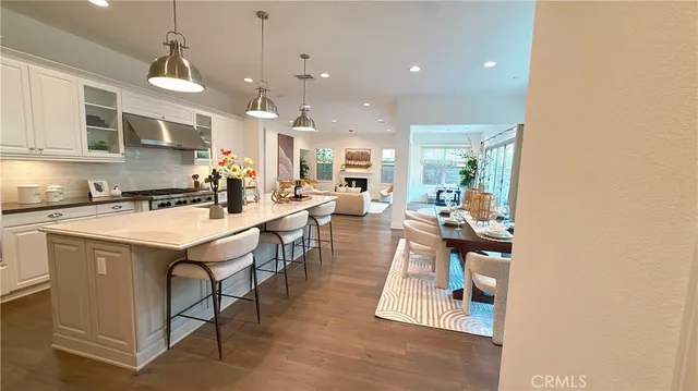 a kitchen with stainless steel appliances kitchen island granite countertop a sink and a refrigerator