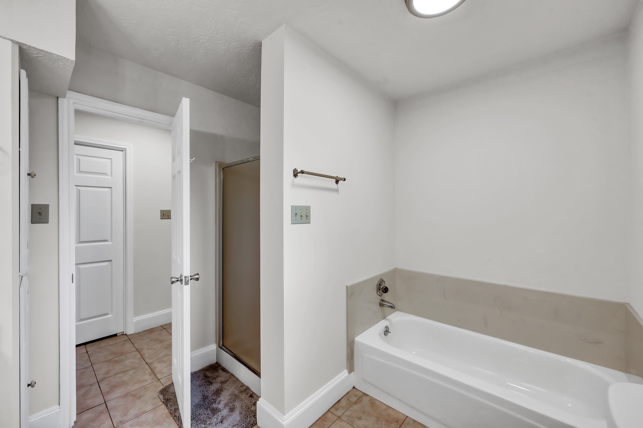 117 Brookside Drive Trinity, TX 75862 - Photo 16 of 46 In this second view of the detached primary bathroom, you can see the separate walk-in shower and bathtub.