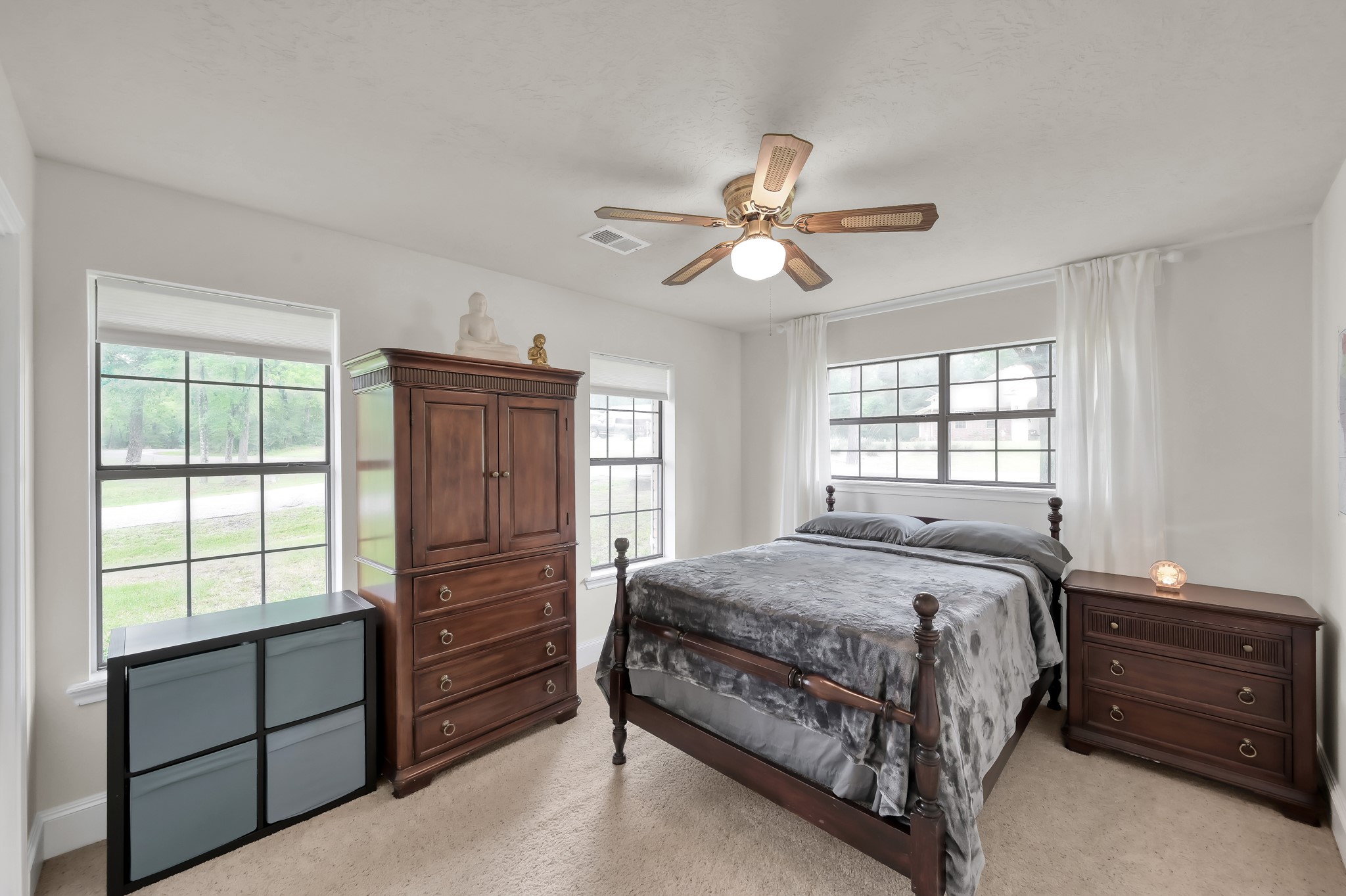 117 Brookside Drive Trinity, TX 75862 - Photo 17 of 46 Showcasing the first of two views of the second downstairs bedroom, featuring lots of natural light streaming in through the windows.