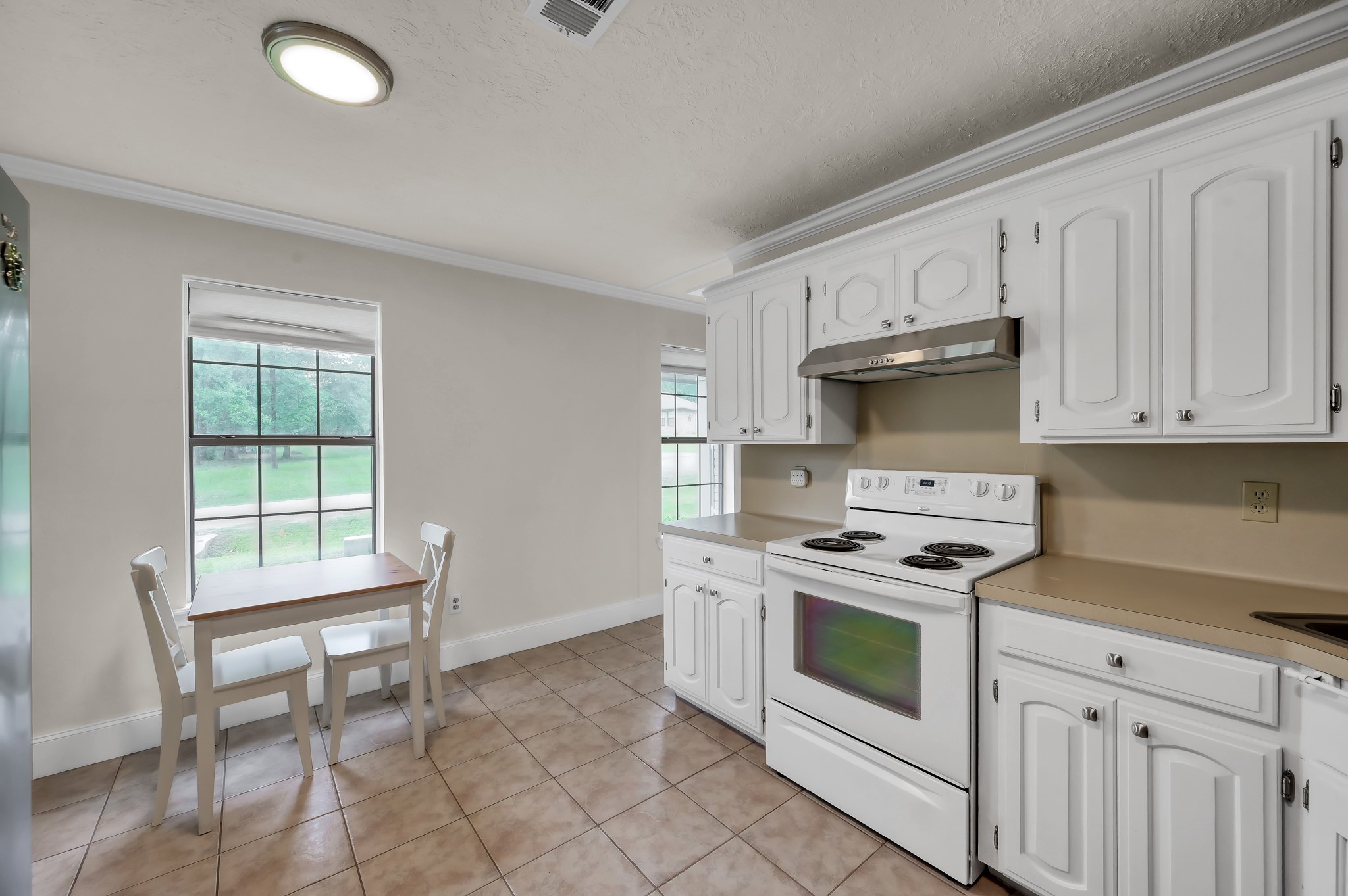 117 Brookside Drive Trinity, TX 75862 - Photo 17 of 46 a kitchen with a stove a sink and a window