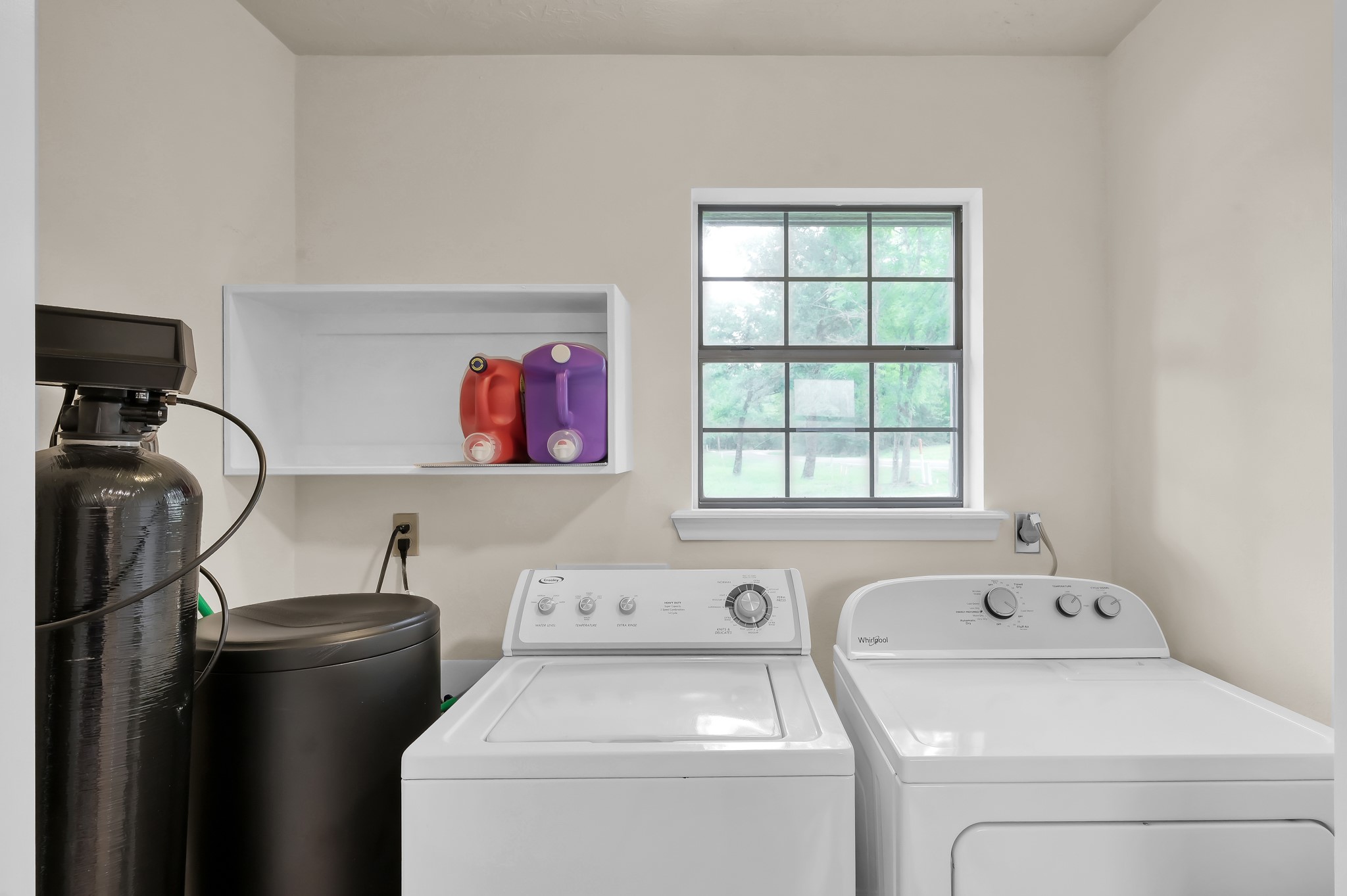117 Brookside Drive Trinity, TX 75862 - Photo 19 of 46 Washer and dryer area, which also includes the water softener, making it a really practical and convenient utility space.