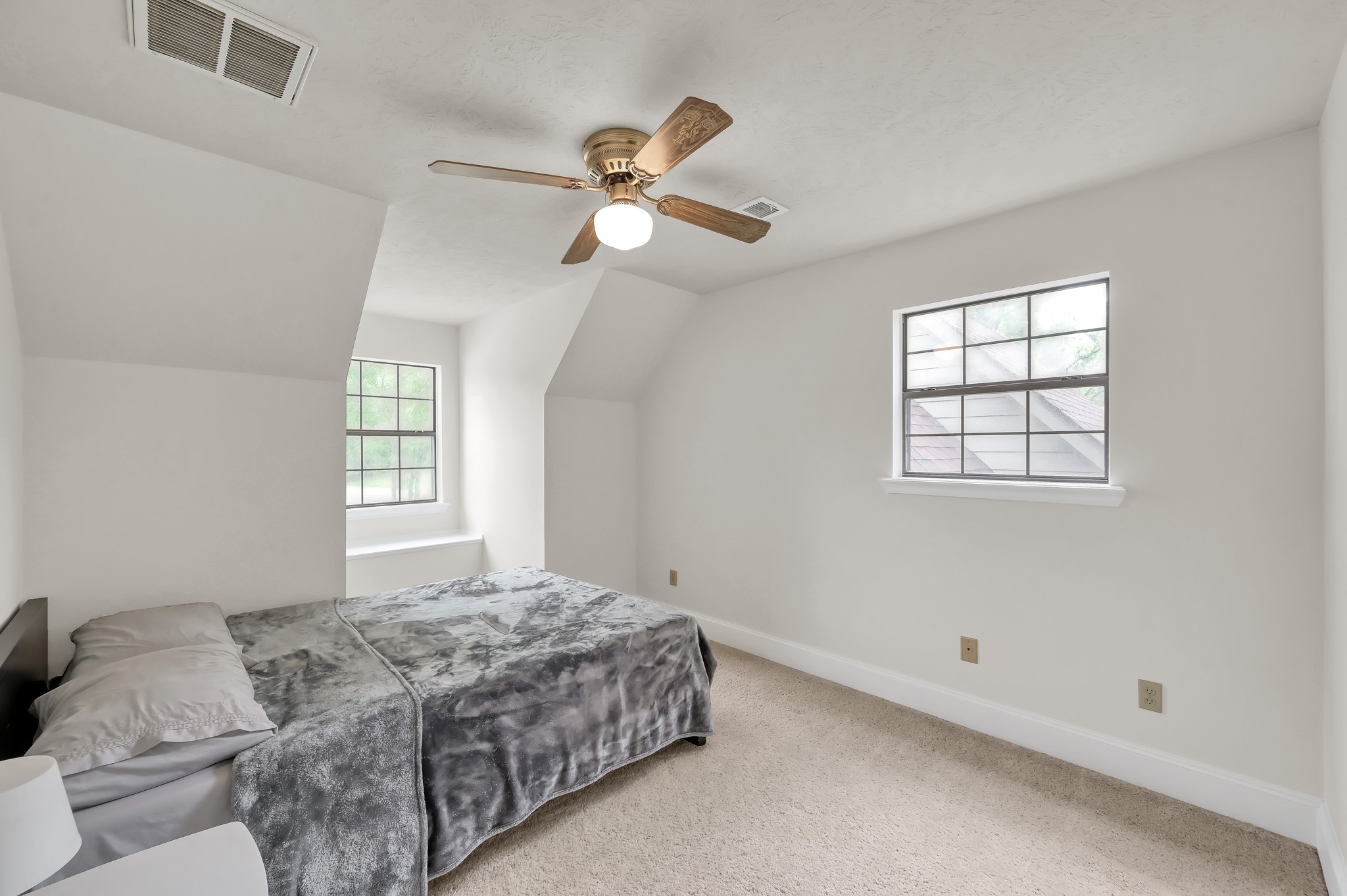 117 Brookside Drive Trinity, TX 75862 - Photo 20 of 46 The first of the two upstairs bedrooms, and you'll notice it really shows off that natural light coming in through the dormer window.