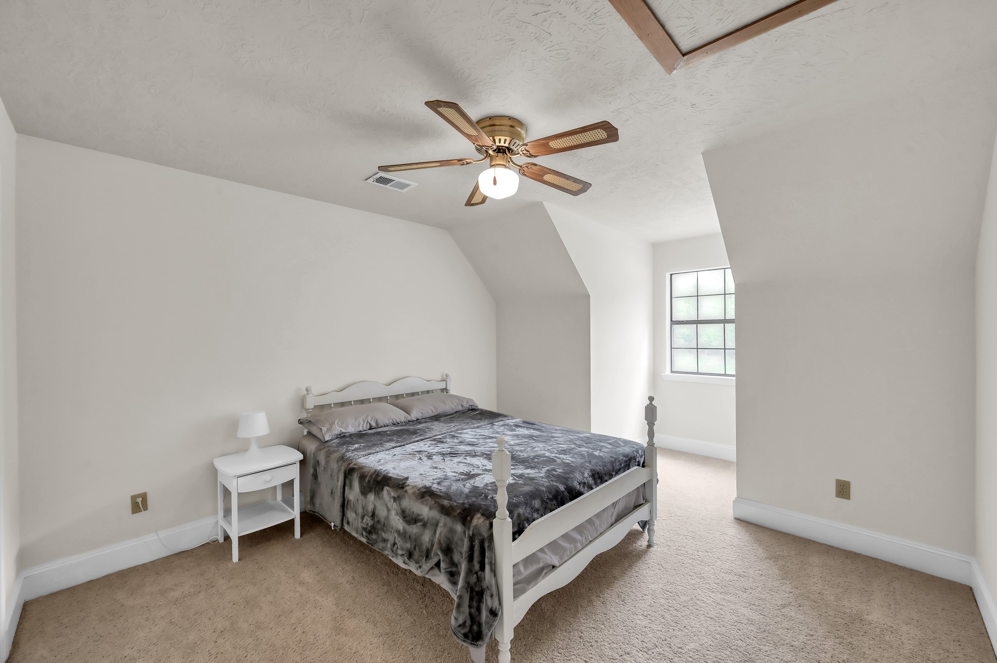 117 Brookside Drive Trinity, TX 75862 - Photo 23 of 46 The second upstairs bedroom. It's also got that beautiful natural light from a second dormer window, just like its counterpart, so it's bright and welcoming as well.