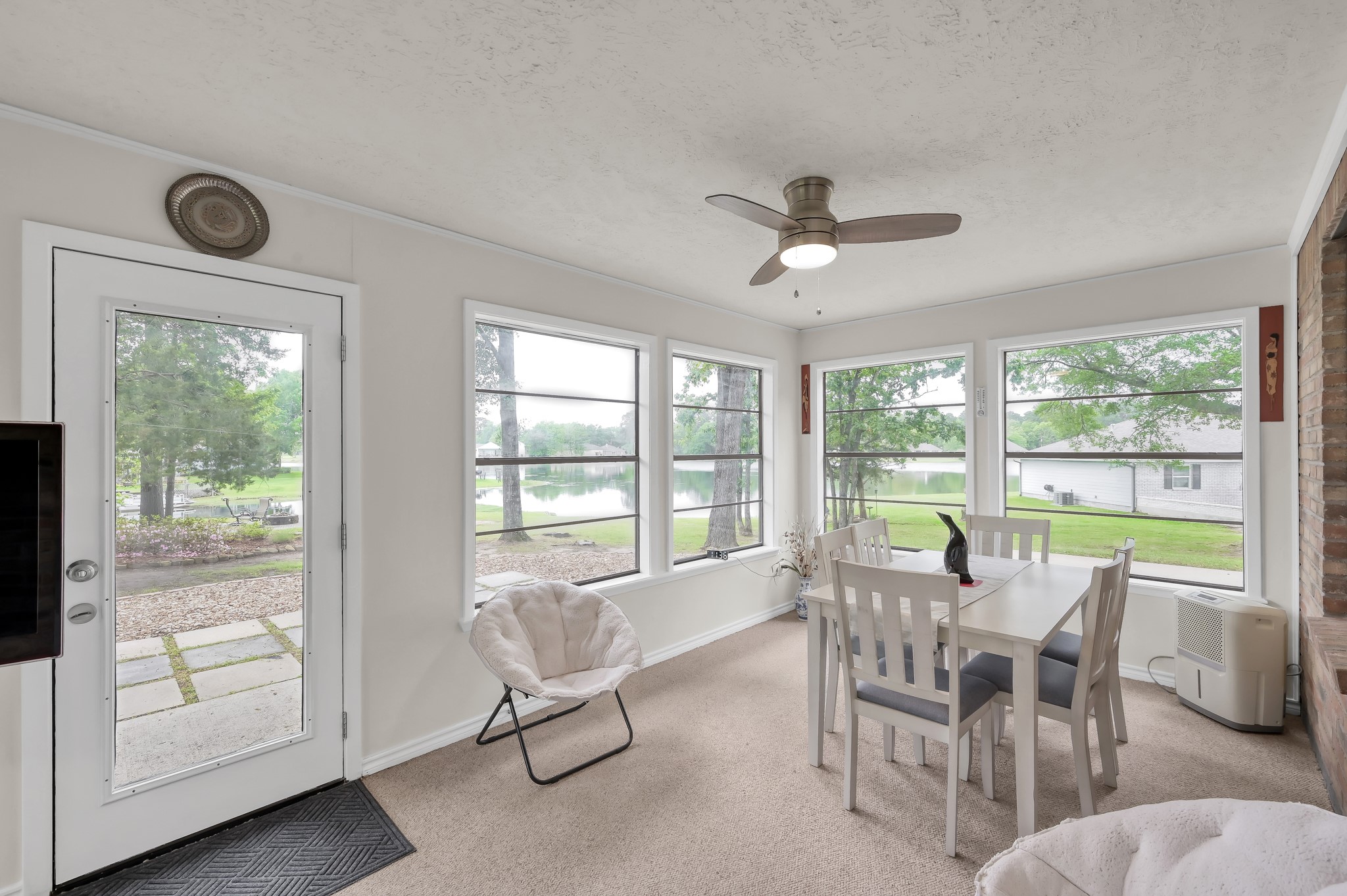 117 Brookside Drive Trinity, TX 75862 - Photo 25 of 46 North-end of the climate-controlled sunroom offering expansive views of the yard and water.