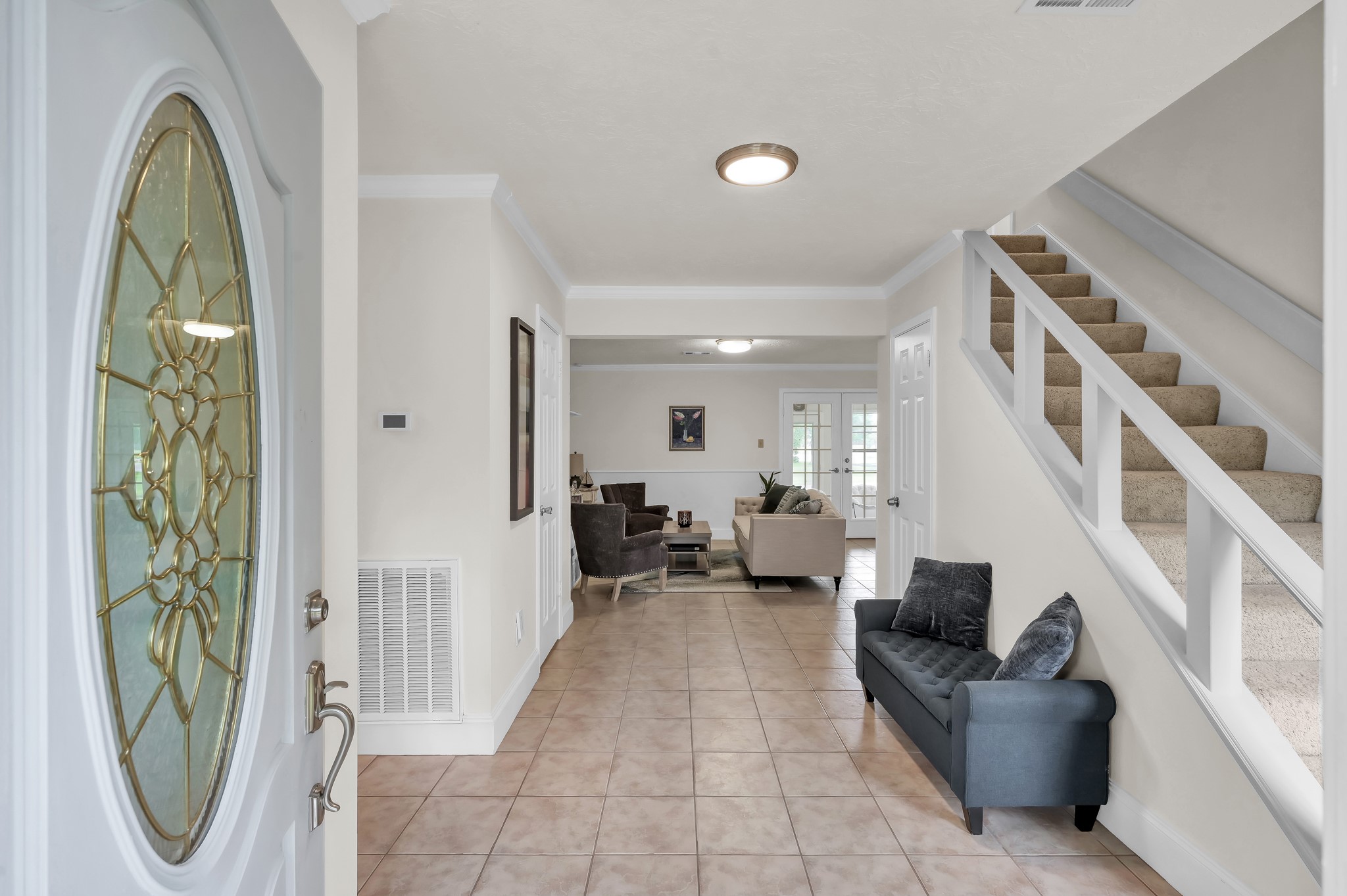 117 Brookside Drive Trinity, TX 75862 - Photo 3 of 46 Welcoming entry with tiled foyer and clear sightline to a bright living area, and stairway to bedrooms on the right.