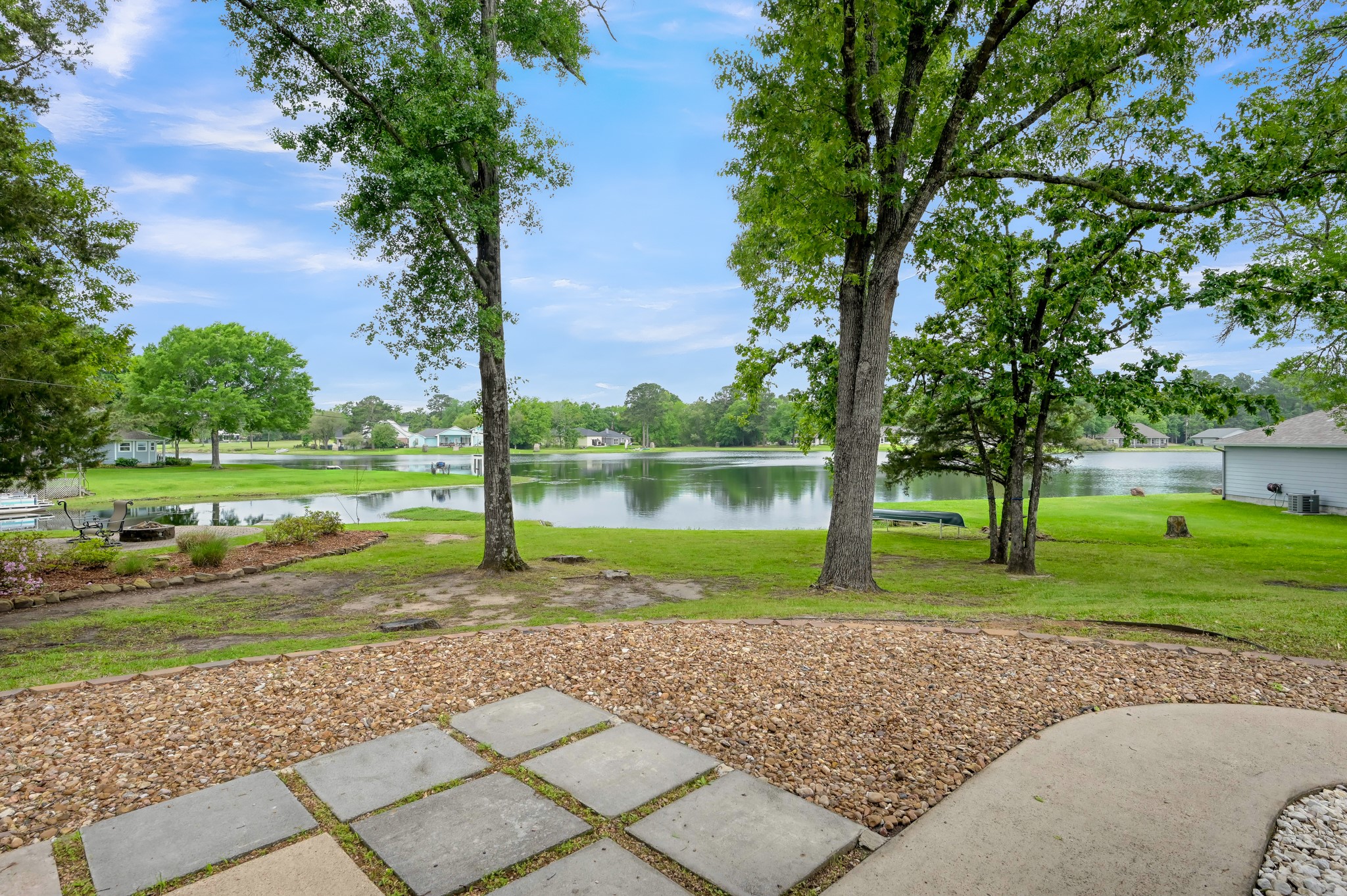 117 Brookside Drive Trinity, TX 75862 - Photo 3 of 46 Back yard, from the back door, showing the beautiful lake view and landscaping.