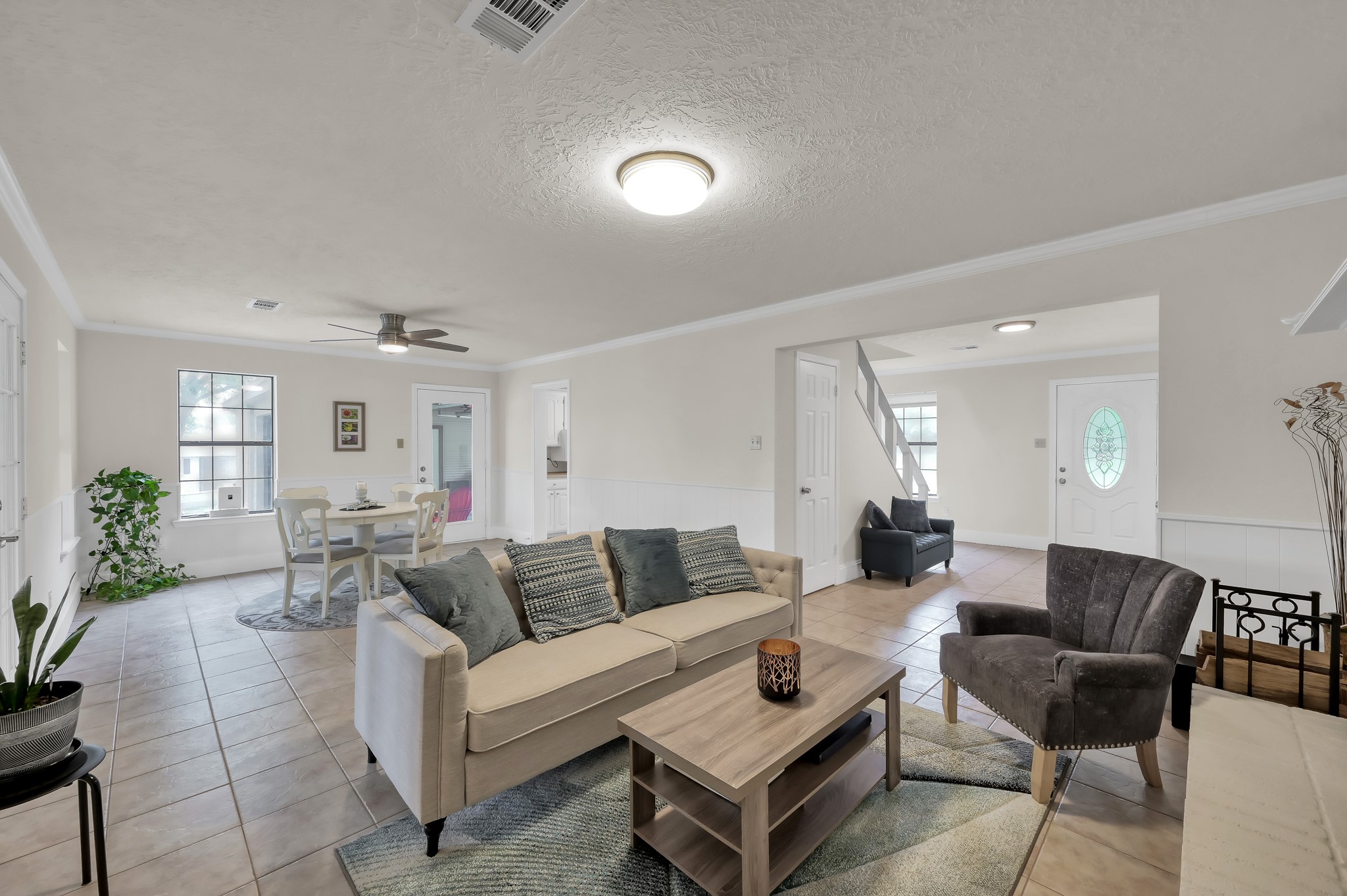 117 Brookside Drive Trinity, TX 75862 - Photo 4 of 46 Combined living and dining area featuring tiled floors, natural light, and a seamless flow into adjoining spaces.