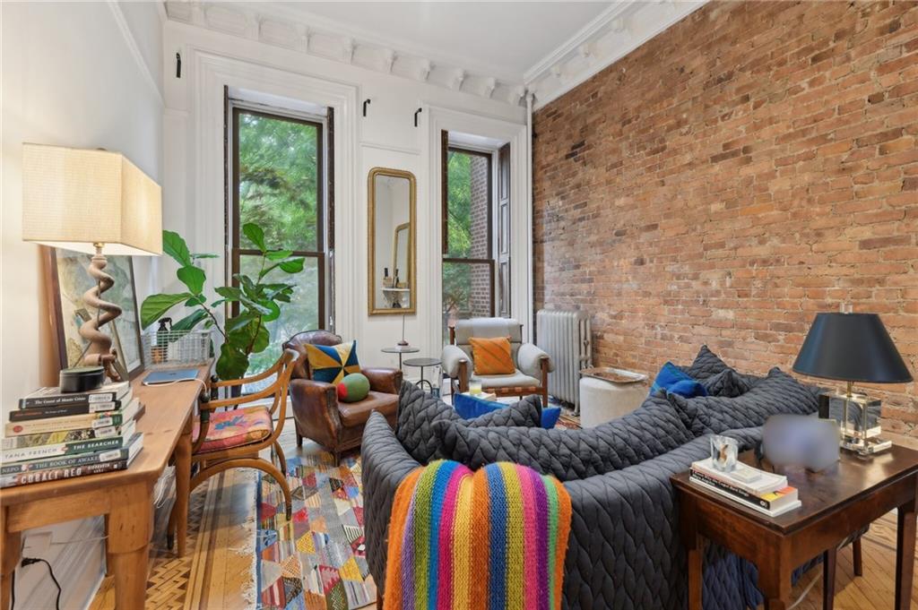 146 St James Place Brooklyn, NY 11238 - Photo 4 of 10 a living room with furniture and a flat screen tv