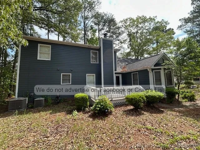 a view of a house with backyard sitting area and garden