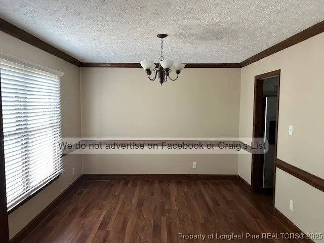 a view of a room with wooden floor and a window