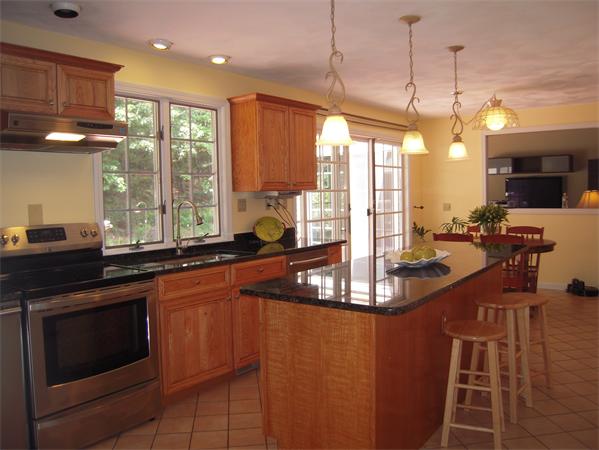 338 Robinson Road Boxborough, MA 01719 - Photo 3 of 18 a kitchen with stainless steel appliances granite countertop a stove a sink and a granite island