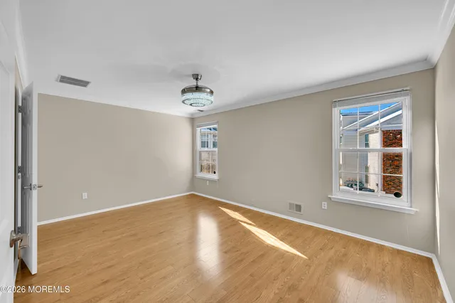 an aerial view of residential houses with outdoor space and trees