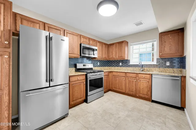 a bathroom with a sink a toilet a shower and a mirror