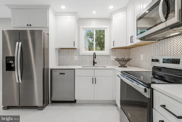 a view of an empty room with wooden floor and window