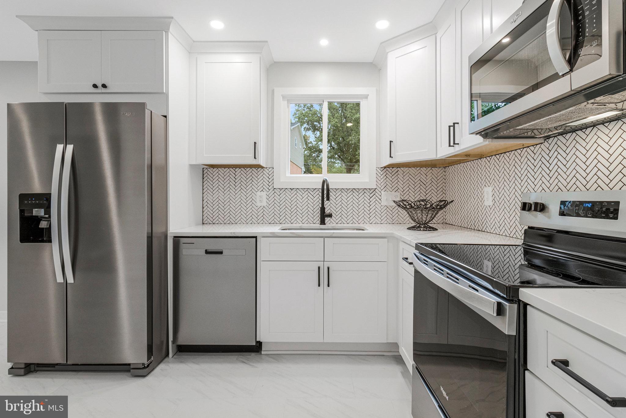 5511 Callander Drive Springfield, VA 22151 - Photo 17 of 74 a kitchen with a sink stainless steel appliances and cabinets