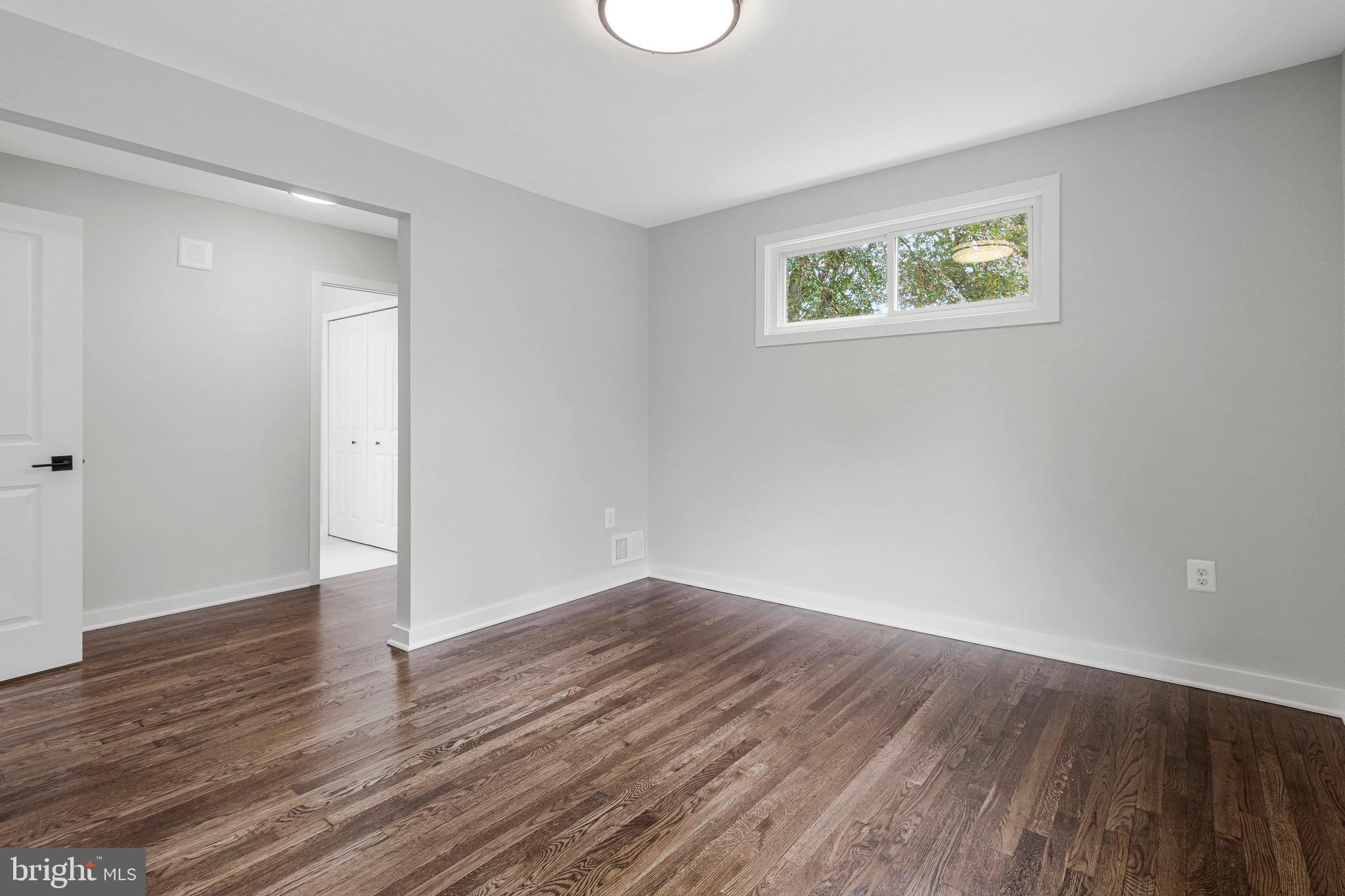 5511 Callander Drive Springfield, VA 22151 - Photo 42 of 74 an empty room with wooden floor and windows