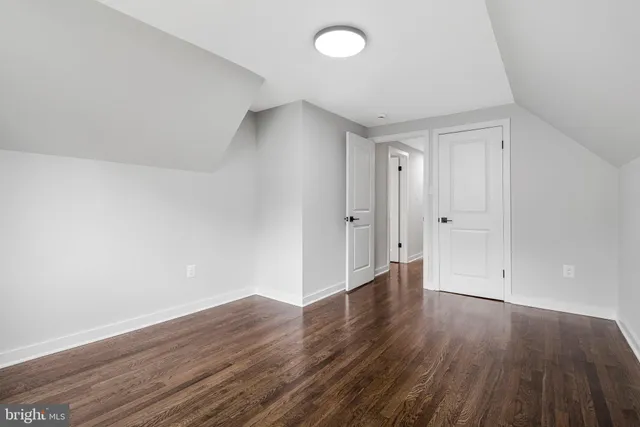 a view of backyard with wooden fence and a large tree