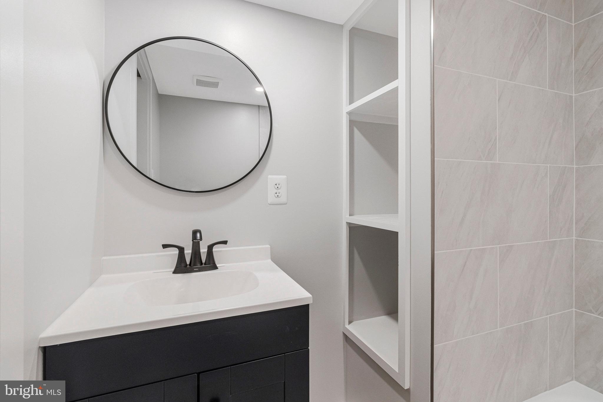 5511 Callander Drive Springfield, VA 22151 - Photo 56 of 74 a bathroom with a sink a toilet and a mirror