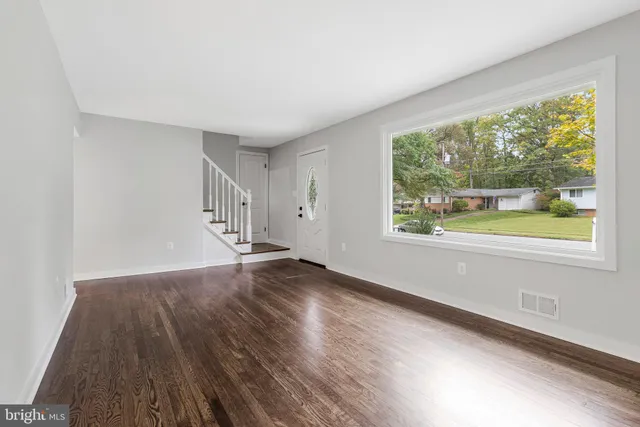 a view of a kitchen with a sink a refrigerator and window