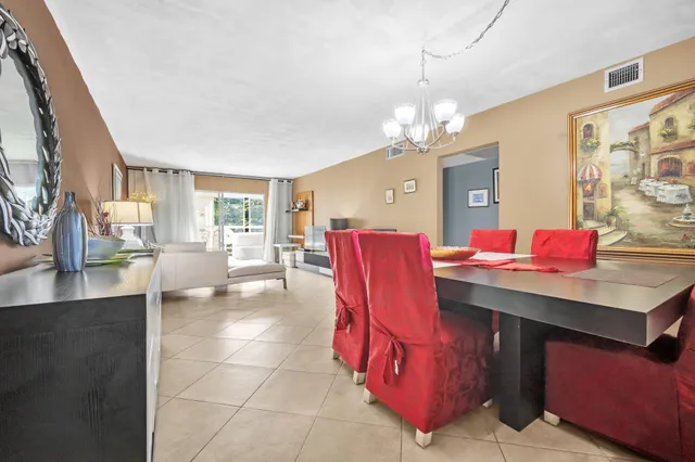 a living room with furniture a chandelier and a dining table