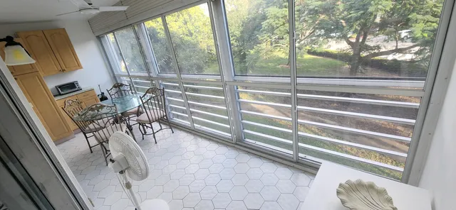 a view of a porch with furniture and a gate