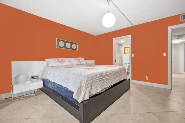 a bedroom with a bed and a lamp