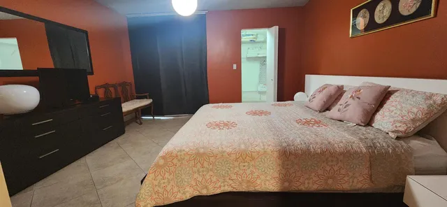 a bedroom with a bed and dresser