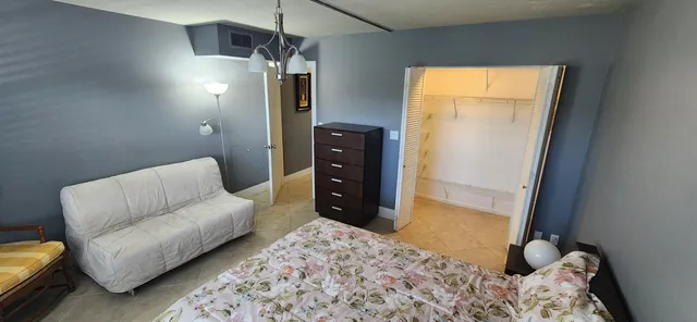 a bedroom with a bed and a couch