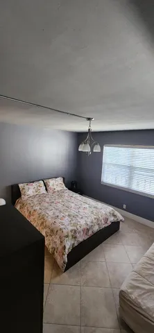 a bedroom with a bed and lamp