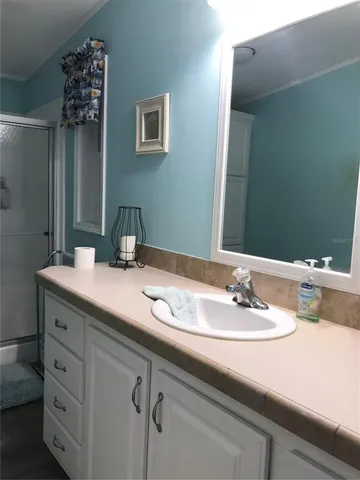 a bathroom with a sink and a mirror