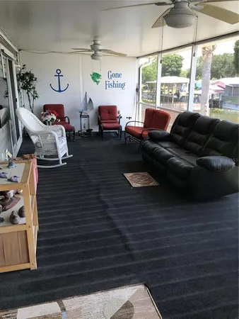 a view of living room filled with furniture and a window