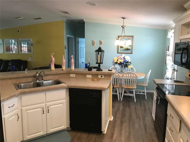 a kitchen with sink cabinets and dining table