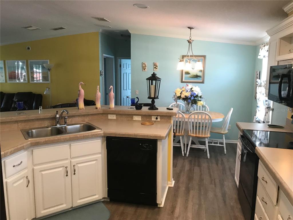 1081 6th Street Okeechobee, FL 34974 - Photo 4 of 22 a kitchen with sink cabinets and dining table