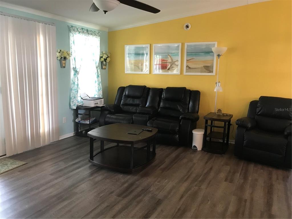 1081 6th Street Okeechobee, FL 34974 - Photo 7 of 22 a living room with furniture and a fireplace