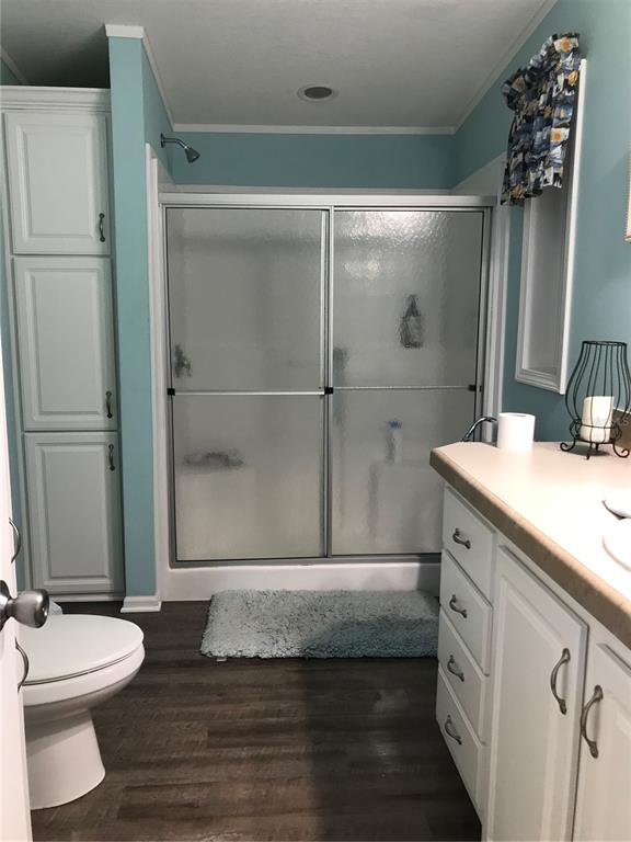 1081 6th Street Okeechobee, FL 34974 - Photo 10 of 22 a bathroom with a double vanity sink toilet and shower