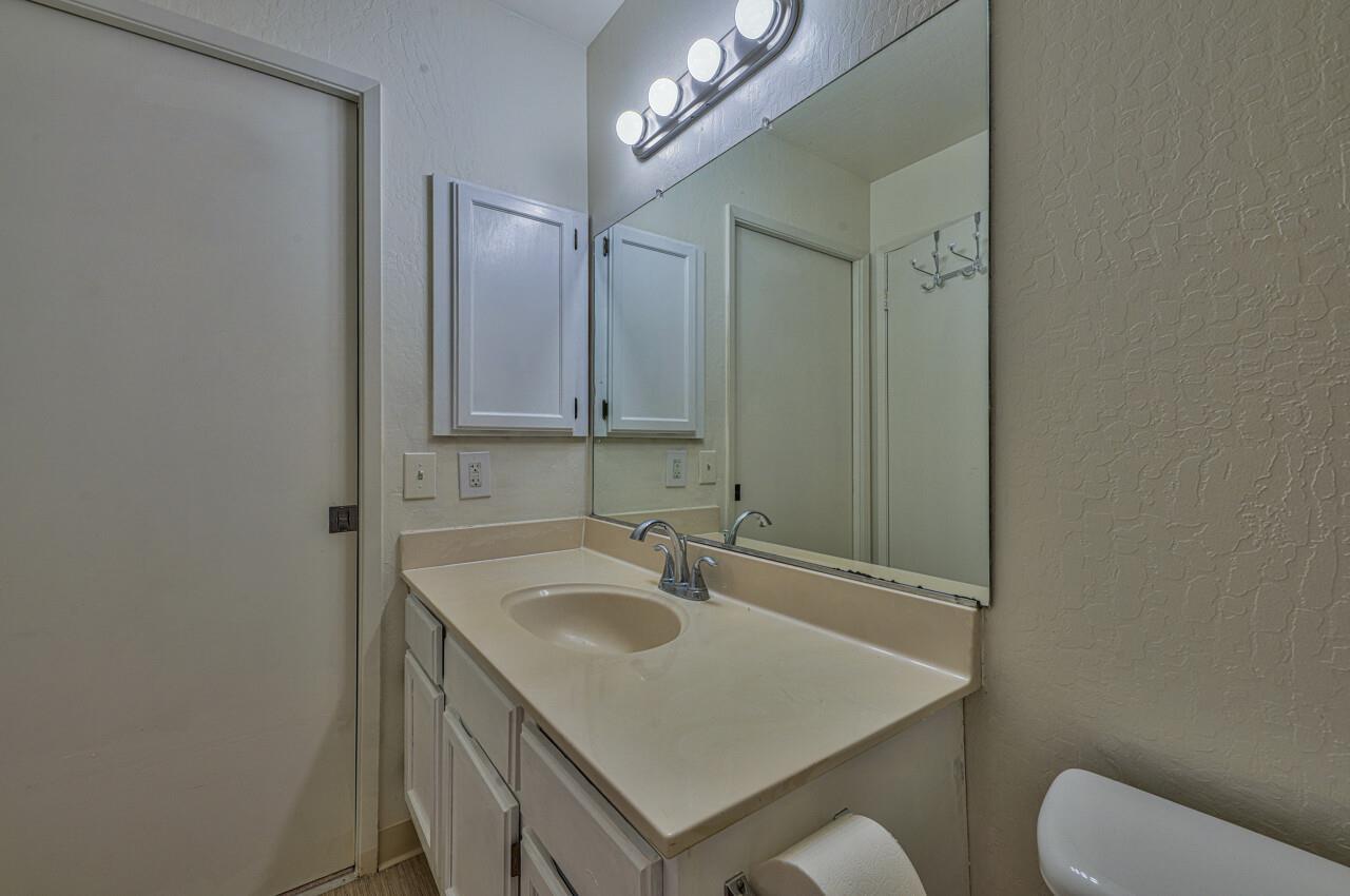 225 Silver Leaf Drive, Unit C Watsonville, CA 95076 - Photo 17 of 24 a bathroom with a sink a toilet and mirror