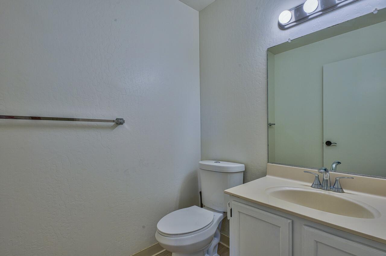 225 Silver Leaf Drive, Unit C Watsonville, CA 95076 - Photo 18 of 24 a bathroom with a toilet a sink and mirror