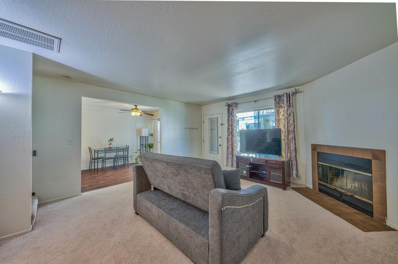 225 Silver Leaf Drive, Unit C Watsonville, CA 95076 - Photo 7 of 24 a living room with furniture and a fireplace