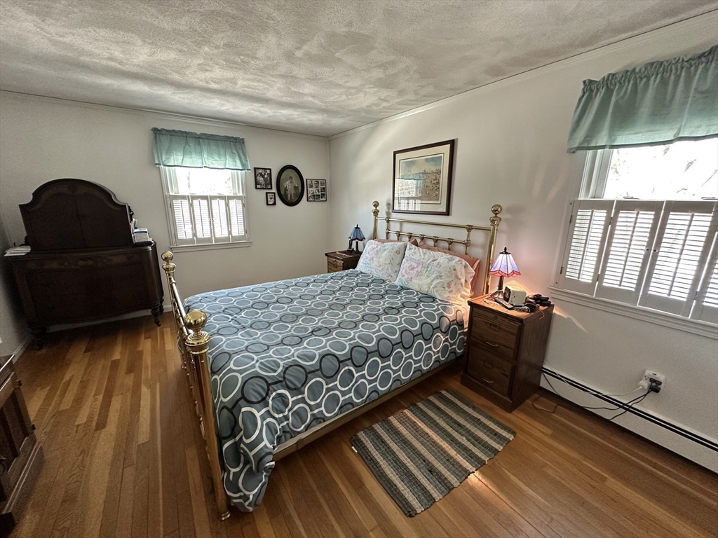 12 Wellington Ln Avenue Lexington, MA 02421 - Photo 11 of 15 a bedroom with a bed and wooden floor